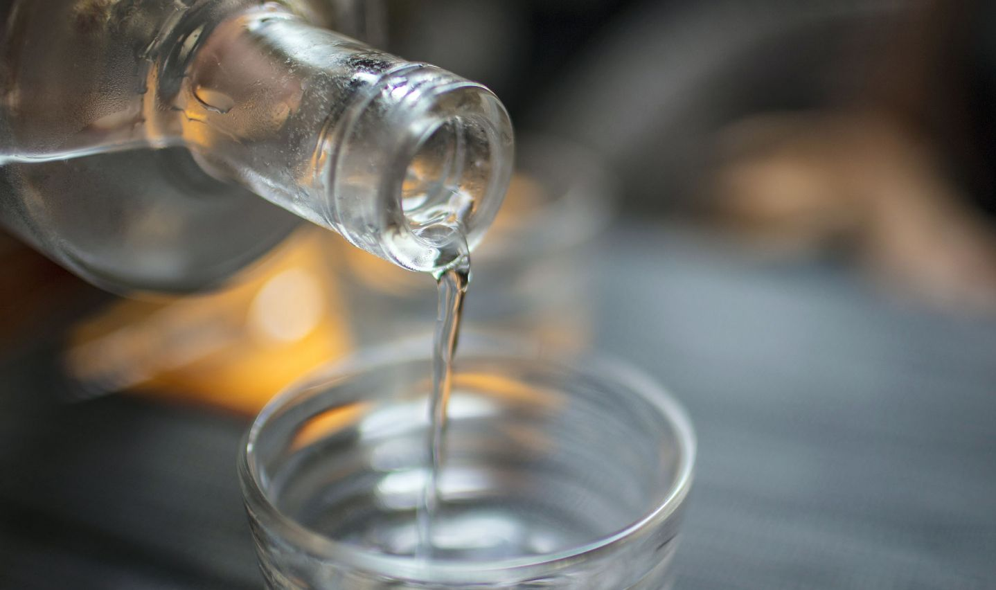 Pouring alcohol to make vanilla extract 